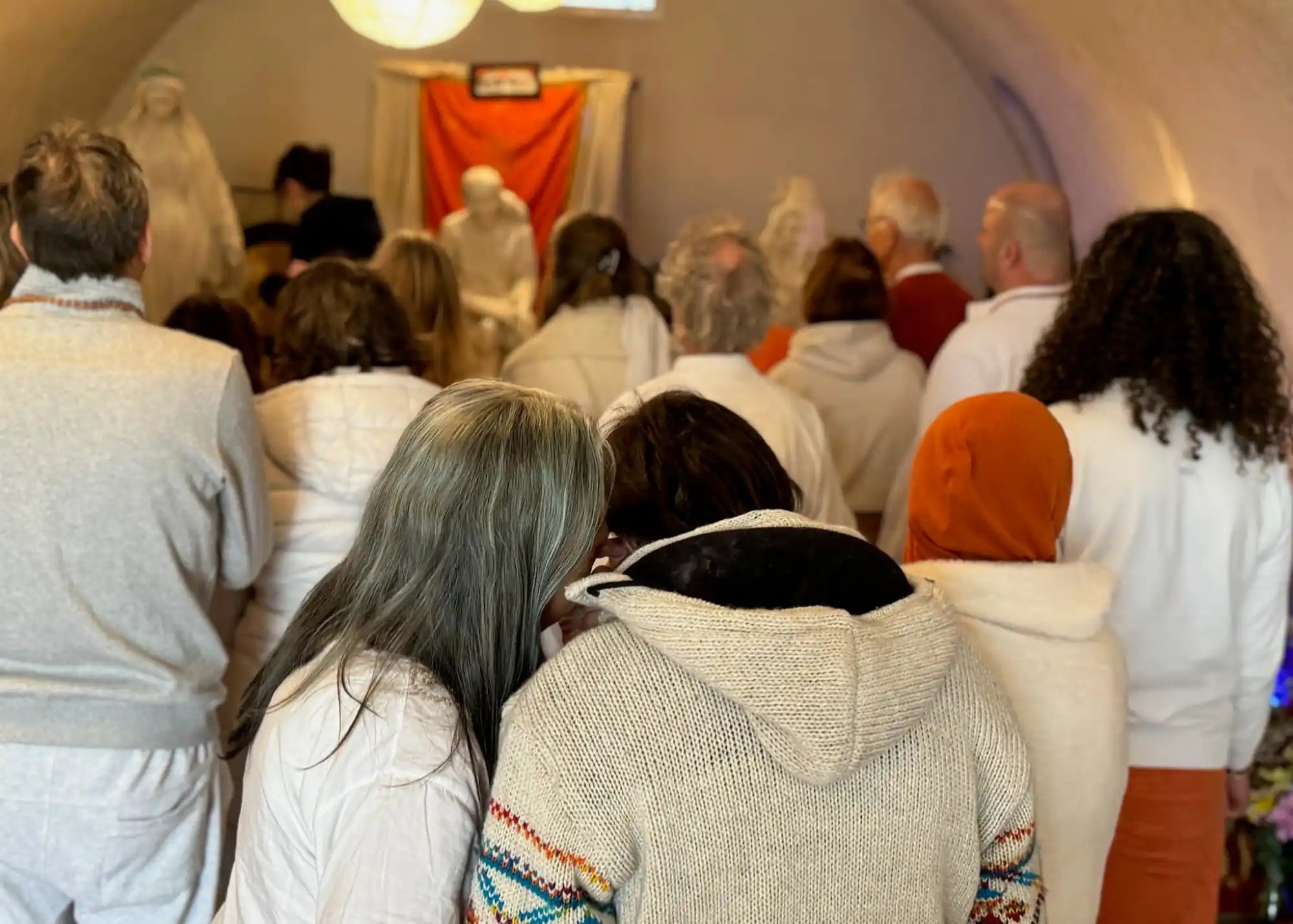 Group of people facing a shrine.