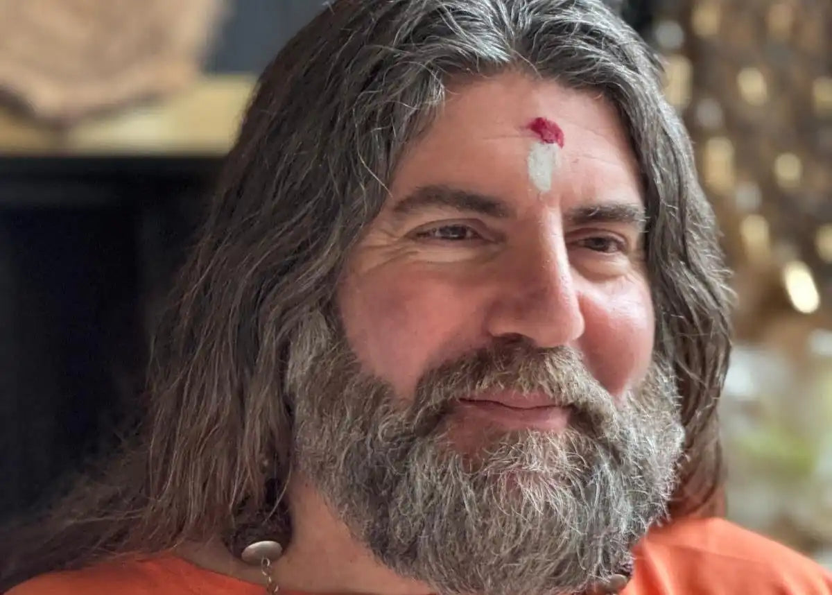 Smiling man with long hair and beard.