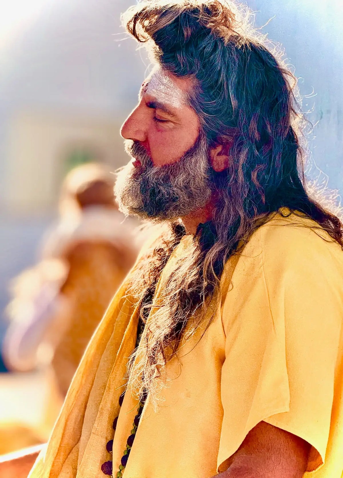 Yellow t-shirt with long hair and beard